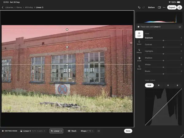 Numa on iPad: a linear mask over the sky of a brick building, shown as a red wash.